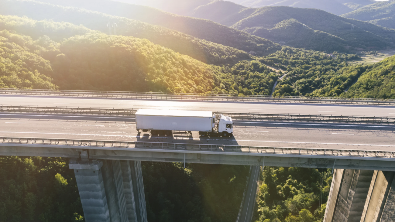 trucks-highway-mountain-sunset