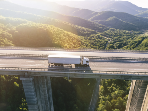 trucks-highway-mountain-sunset